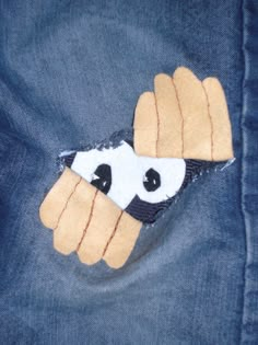 a close up of a pair of jeans with patches on them