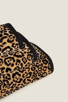 a leopard print purse with black straps