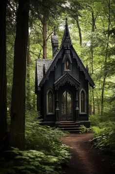 a small black house in the woods surrounded by trees