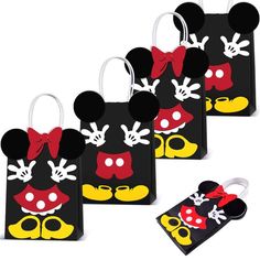 four mickey mouse bags with red bows and yellow shoes on them, all decorated in different colors