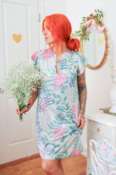 Details: The perfect summertime lounging piece is simple, lightweight, and soft on the skin; the nightgown is made of a unique nylon material printed with blue and teal leaves and magenta flowers. This material gives an earthy, almost fairy vibe. The neckline has a single button with a keyhole cut out, giving it a deep v in the neckline.  Brand: Vanity Fair Size: Small - The model is 5'3" with a 32A bust. Condition:  Excellent condition  Material: 100% Nylon *Please note - Signs of wear are typi Green Summer Nightgown For Sleepover, Green Short Sleeve Summer Nightgown, Green Summer Nightgown, Multicolor Summer Nightgown For Bedtime, Multicolor Summer Nightgown For Sleep, Summer Floral Print Nightgown, V-neck Summer Sleepwear For Hospital, Multicolor Nightgown For Beach, Spring Season, Multicolor Beach Nightgown For Spring