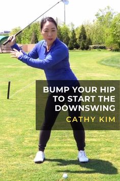 a woman swinging a golf club on top of a green field with the words bump your hip to start the downswing