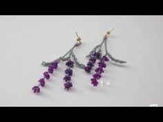 two pairs of earrings with purple beads hanging from them