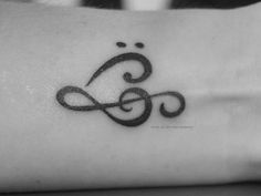 a black and white photo of a tattoo on the wrist