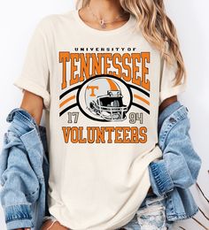 a women's tennessee volunteers shirt with an orange and white football helmet on it