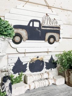 an old truck with pumpkins is hanging on the wall