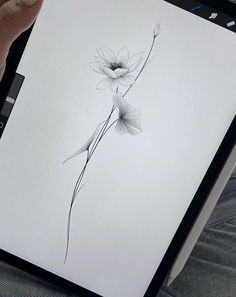 a person holding an ipad with a drawing on the screen and a flower drawn on it