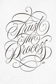 the words trust the process written in cursive writing on white paper with black ink