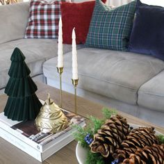 a living room filled with furniture and christmas decorations on top of a wooden coffee table