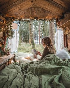 a woman sitting in bed reading a book