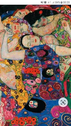 two women are laying on a colorful blanket