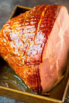 a large piece of meat sitting on top of a pan