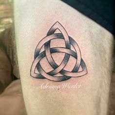 a man's leg with a tattoo on it that has an image of a celtic knot