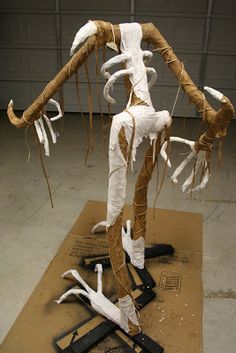 an animal skeleton is on display in a garage with other parts attached to the floor