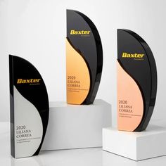 three award plaques sitting on top of each other in front of a white background with the words baxter