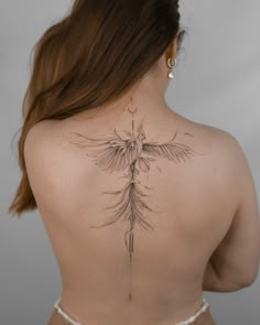 the back of a woman's neck with a tattoo on it