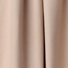 a close up view of the side of a curtain with pleated edges and buttons