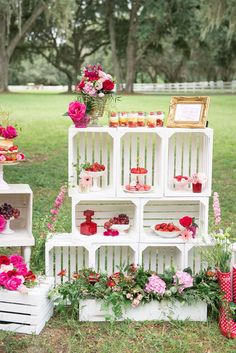 an assortment of flower pots and vases on display in the grass at a wedding