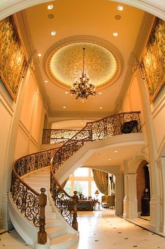 a large foyer with stairs and chandelier