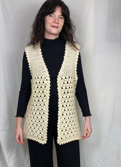 Channel effortless 70s boho vibes with this stunning vintage white crochet waistcoat. This long, open-knit vest adds texture to any outfit, perfect for layering over dresses or pairing with jeans for a casual look. The  crochet pattern gives it a timeless, handmade feel, making it a standout piece in any wardrobe.  By choosing vintage clothing like this cardigan, you're not only adding unique pieces to your wardrobe but also contributing to sustainable fashion practices. Reduce waste and make a Fall Sleeveless Crochet Top With Crochet Trim, Sleeveless Crochet Top With Crochet Trim For Fall, Sleeveless Crochet Lace Top For Fall, White Bohemian Sweater Vest For Spring, Vintage Crochet Sleeveless Vest, Vintage Sleeveless Crochet Top For Spring, White Bohemian Crochet Vest Top, Fitted Beige Bohemian Vest, Bohemian Fitted Beige Vest