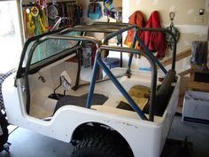 a white vehicle parked inside of a garage