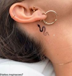 a close up of a person with a tattoo on their ear and behind the ear