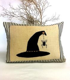 a black and white pillow with an image of a witch's hat on it