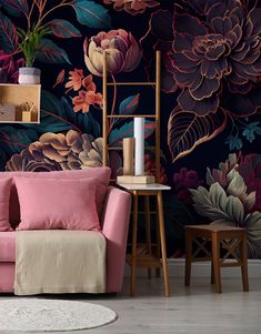 a pink couch sitting in front of a wall with flowers on it and two chairs next to it