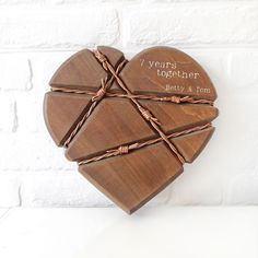 a heart shaped box with twine wrapped around it and the words i love you together