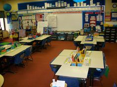 an empty classroom with desks and chairs