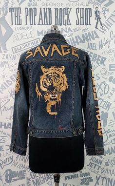 Beautifully hand painted dark blue denim jacket with a Royal Bengal tiger motif at back.It is embellished with antique copper studs and spokes which  give it a rock star feel.The front and both sleeves also have painted motifs and trendy words hand painted with metallic copper fabric paint.The fabric quality is at par with the best and the colours used are non toxic,long staying and durable. Royal Bengal Tiger, Trendy Words, Copper Fabric, Dark Blue Denim Jacket, Hand Painted Denim, Trendy Outerwear, Paris Jackson