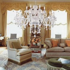 a living room filled with furniture and a chandelier