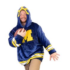 Introducing the University of Michigan Helmet Snugible: a spirited blend of comfort and Wolverines pride! This officially licensed Snugible features the iconic helmet design, perfect for showcasing team allegiance at game nights or cozy evenings. Crafted with ultra-soft fabric, it's oversized and doubles as a hooded blanket. Hoodie Pillow, Sweatshirt Blanket, Reversible Blanket, Blanket Hoodie, Game Nights, Hoodie Blanket, Helmet Design, Hooded Sweatshirt Men, University Of Michigan