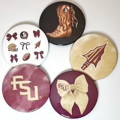 four button badges with different designs on them