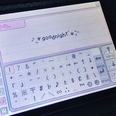 a computer screen with the word goodnight written on it's display panel, in front of a keyboard