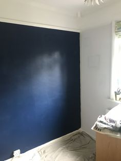 an empty room with blue paint on the wall