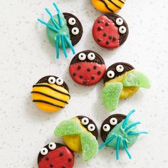 decorated cookies are arranged in the shape of ladybugs, spider, and caterpillars