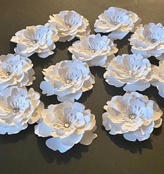 white paper flowers arranged in a circle on a table