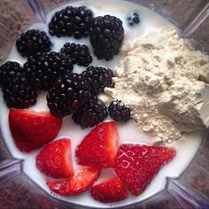 berries, cream and powder in a blender