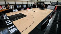 an indoor basketball court in the middle of a building with black and white lettering on it