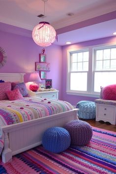 a bedroom decorated in pink, purple and blue