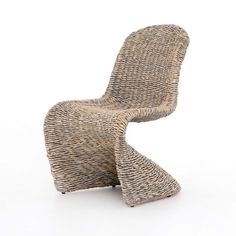 a chair made out of wicker sitting on top of a white floor