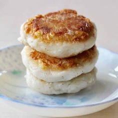 two biscuits are stacked on top of each other in a blue and white plate,