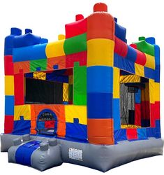 an inflatable bounce house with slide and blow up door for kids to play