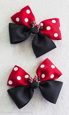 two red and black bows with white polka dots