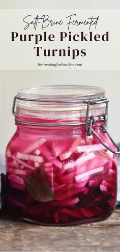 a jar filled with purple pickled turnips on top of a wooden table