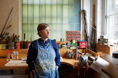 a woman standing in front of a workbench