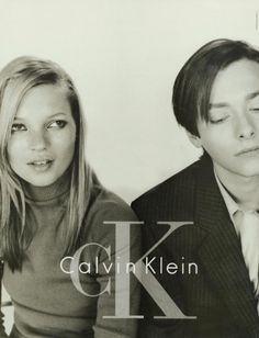 a man and woman posing for a black and white photo with the letter k on it