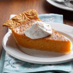 a slice of pumpkin pie with whipped cream on top