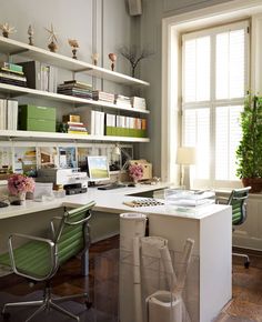 a home office with desk, chair and bookshelf full of books on shelves